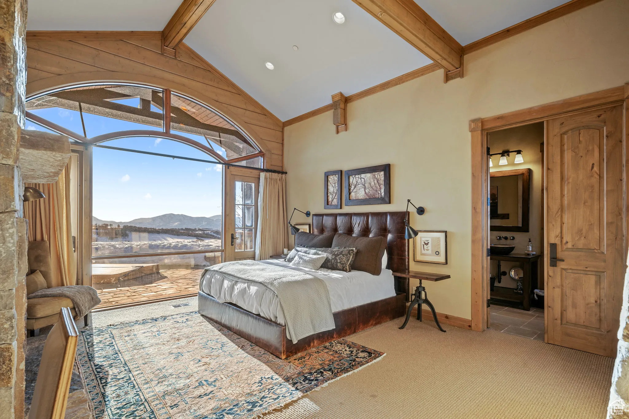 Bedroom with access to exterior, carpet floors, a mountain view, high vaulted ceiling, and beamed ceiling