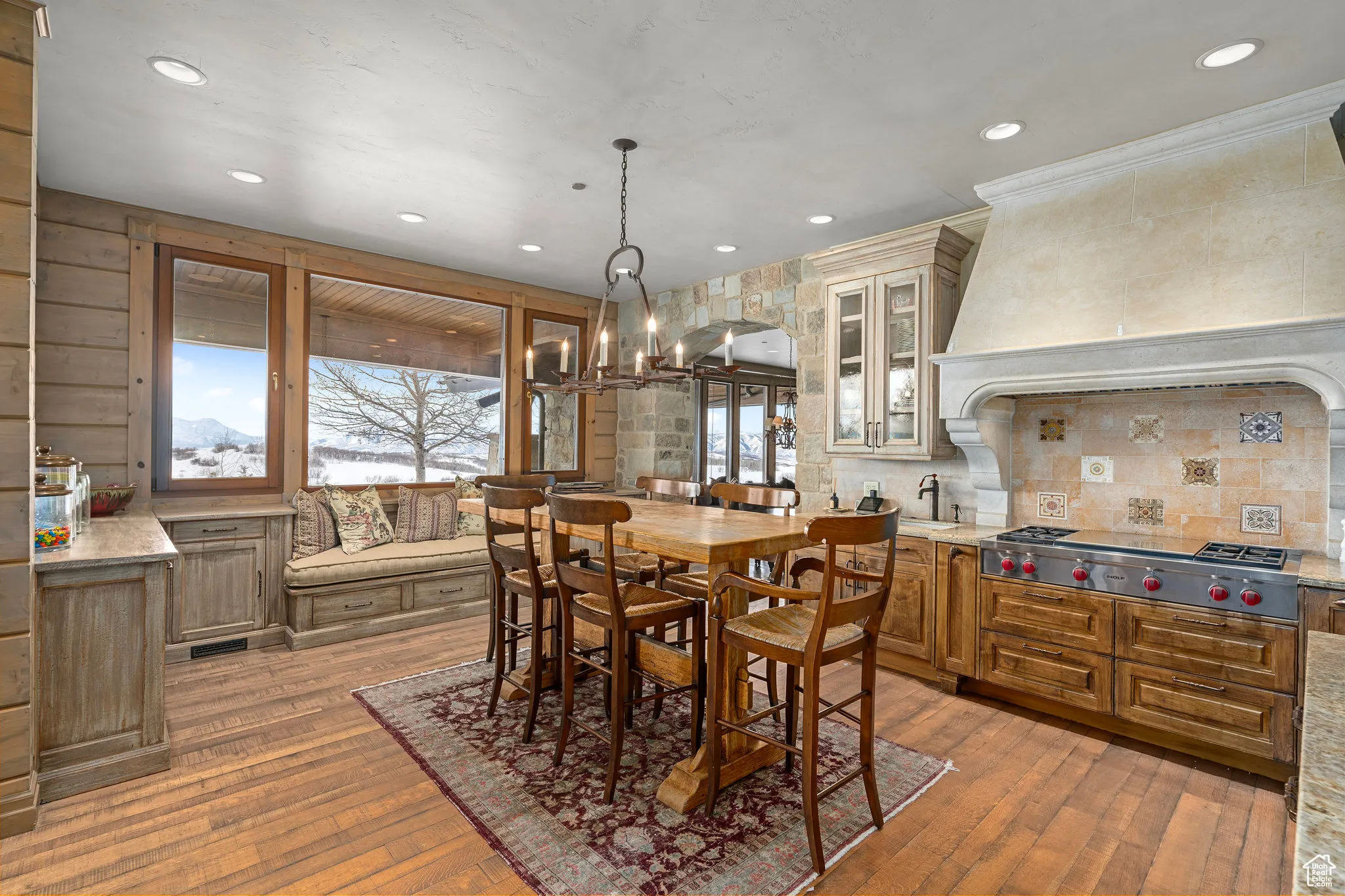 Dining area in kitchen with hardwood / wood-style flooring, ornamental molding, a notable chandelier, and recessed lighting