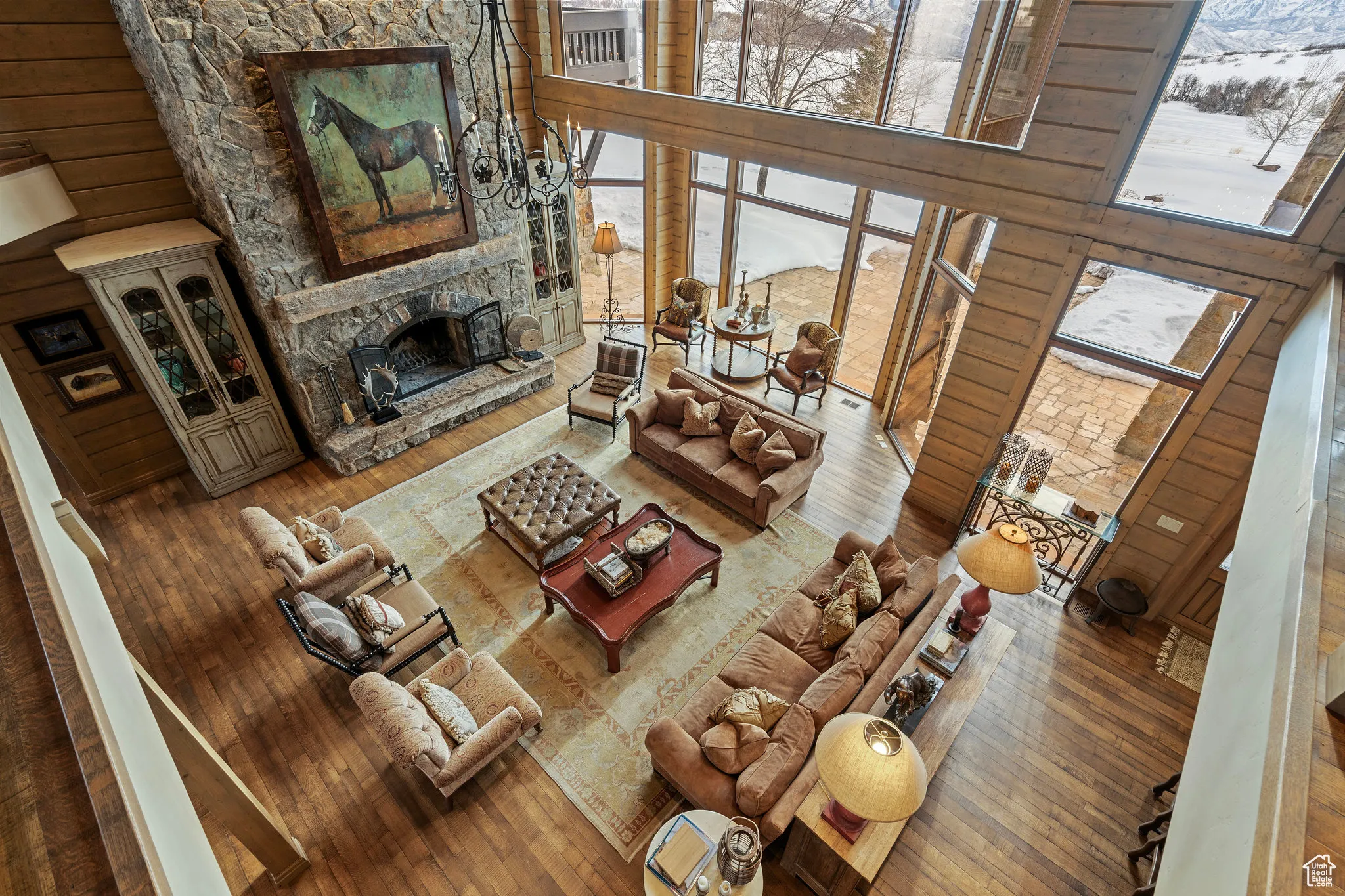 Living room featuring a fireplace, a towering ceiling, and hardwood / wood-style floors