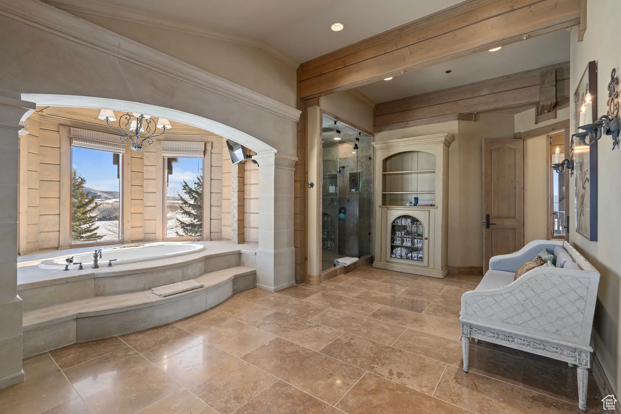 Full bathroom featuring crown molding, a shower stall, baseboards, and a bath