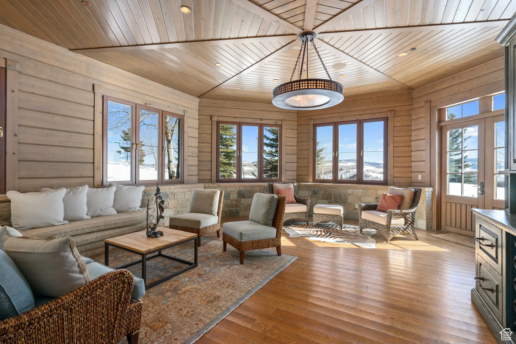 un filled living space with wooden ceiling, wood-type flooring, and a wealth of natural light