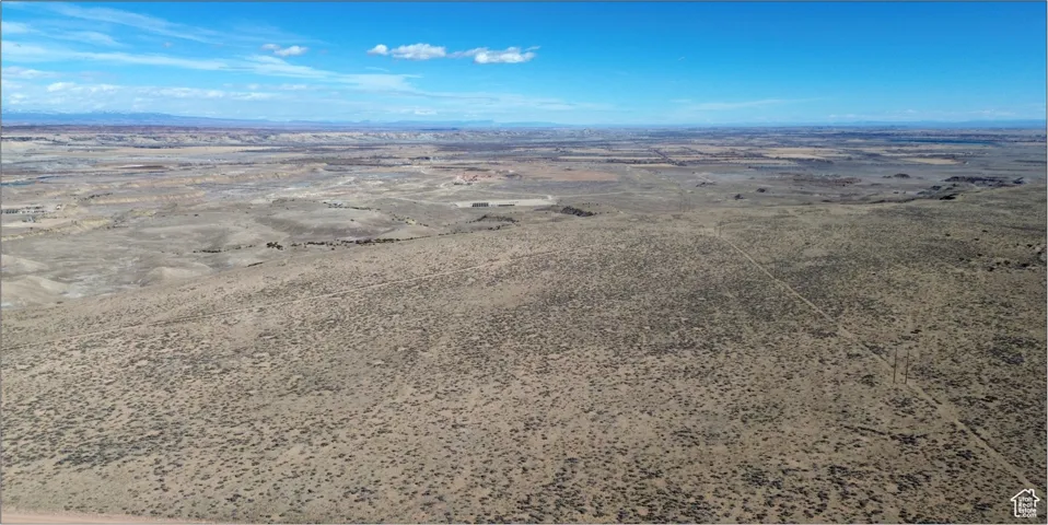 Birds eye view of property with a mountain view and view of desert