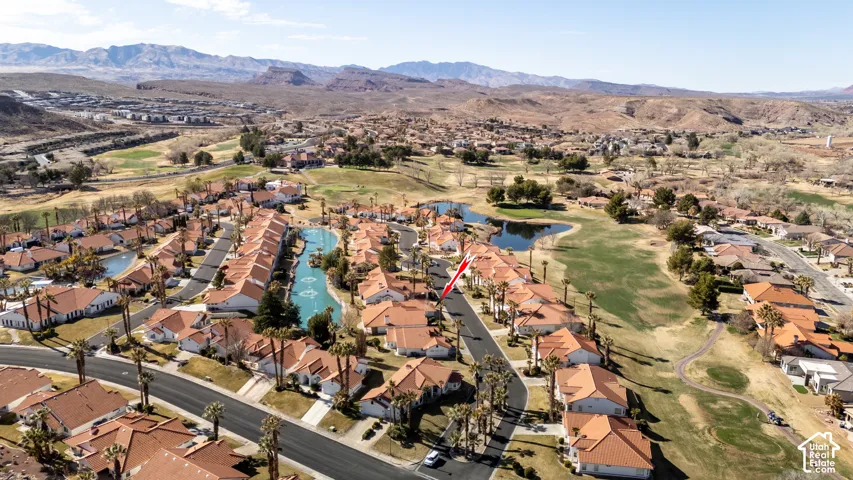 Drone / aerial view with view of golf course, a residential view, and a water and mountain view
