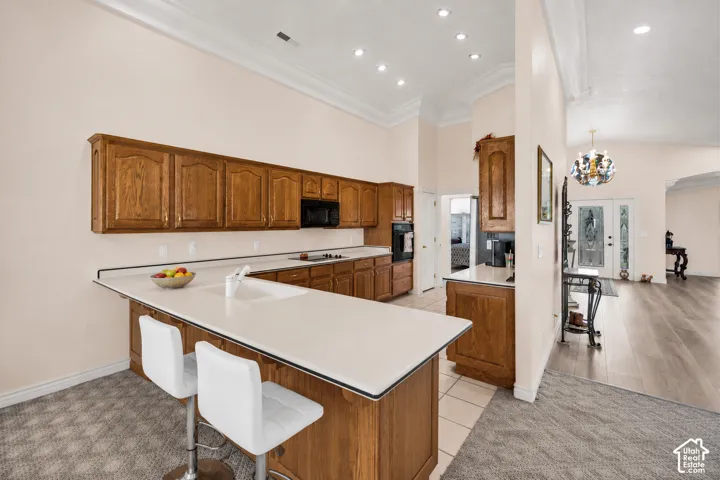 Kitchen featuring wood cabinetry, white countertops, built-in microwave, integrated sink, and recessed lighting