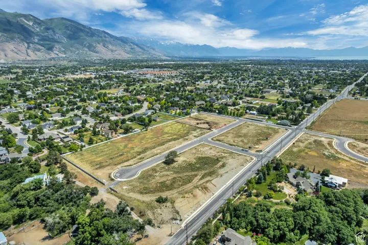 Aerial view of property and surrounding area featuring mountains