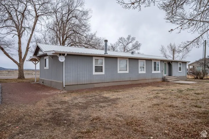 Back of house featuring metal roof