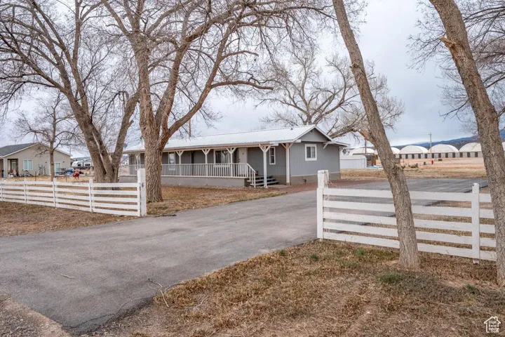 View of front of house featuring a fenced front yard, a residential view, and covered porch