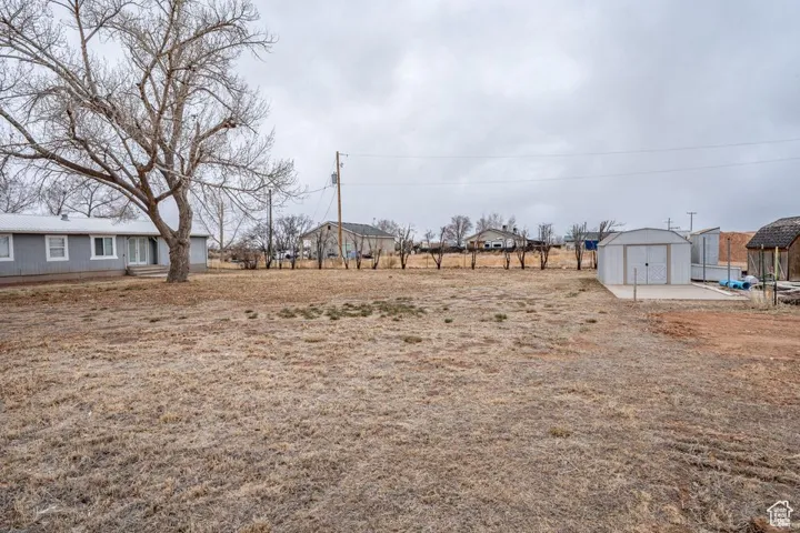 View of yard with a storage shed and an outdoor structure