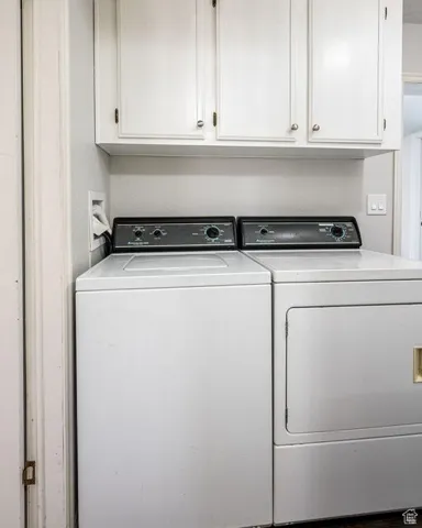 Clothes washing area with washer and dryer and cabinet space