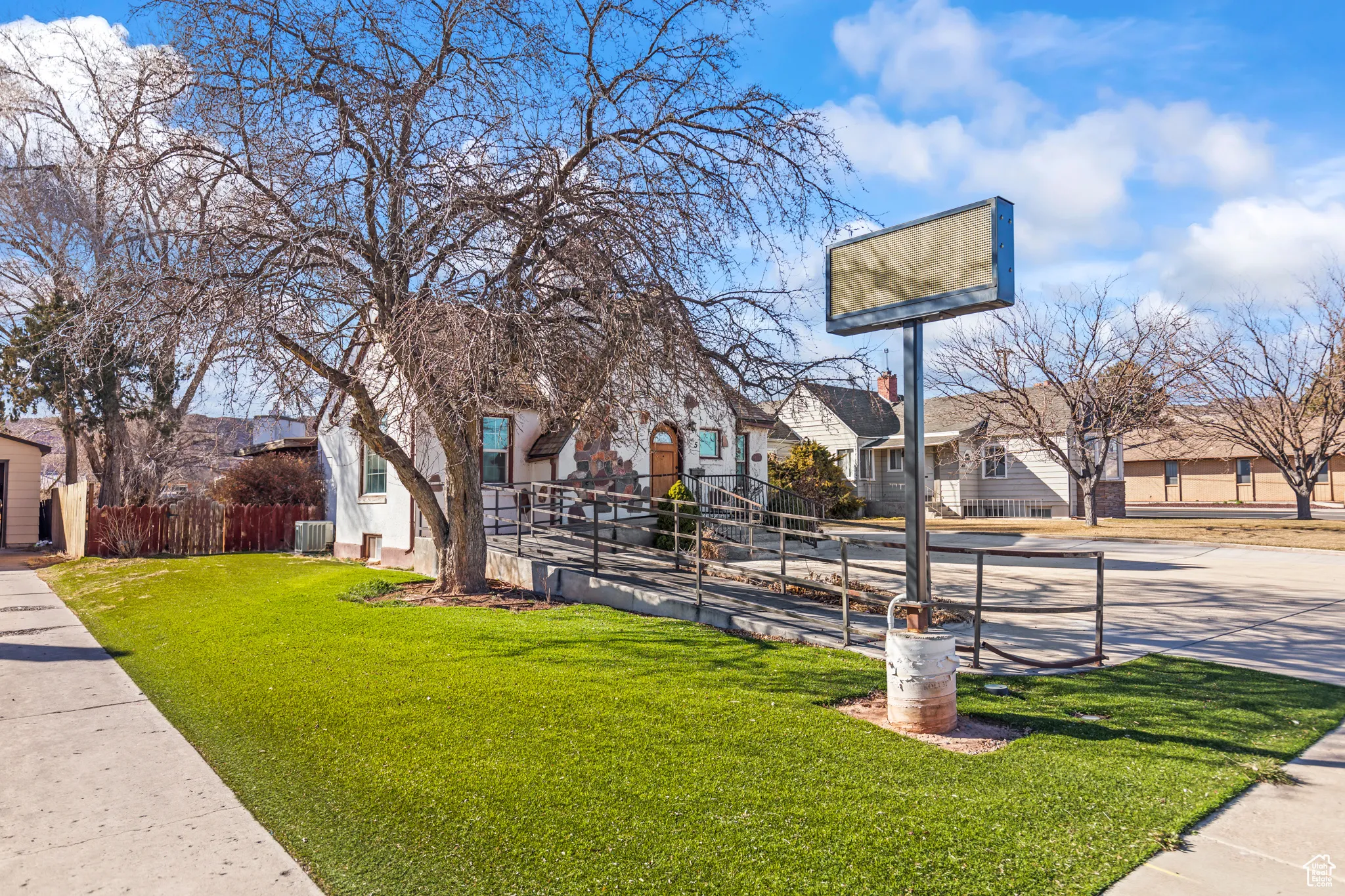 View of home's community with a yard, fence, and a residential view