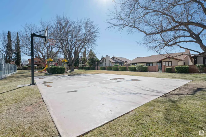 View of sport court with a residential view, community basketball court, and a yard