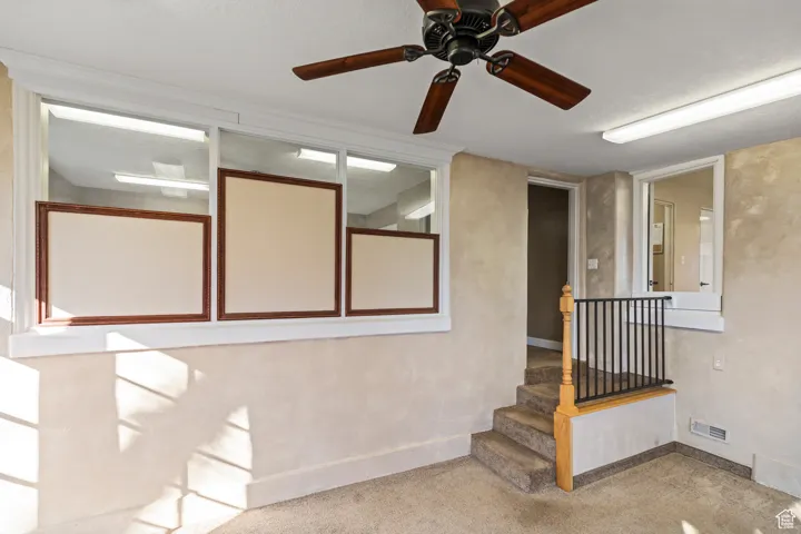 Doorway to property featuring visible vents and ceiling fan