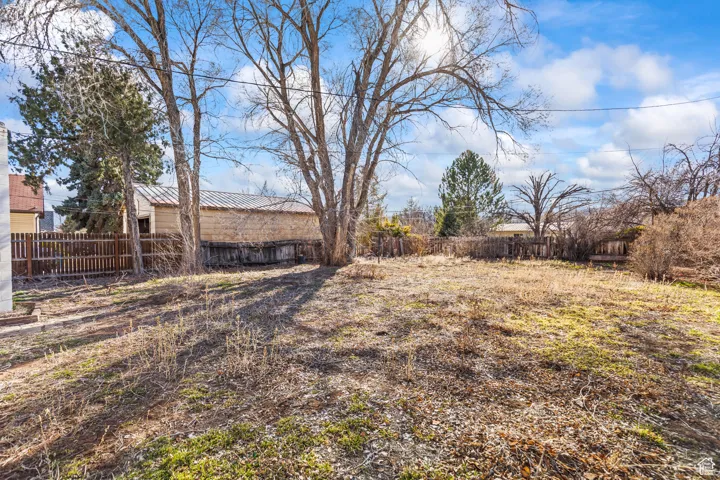 View of yard featuring fence