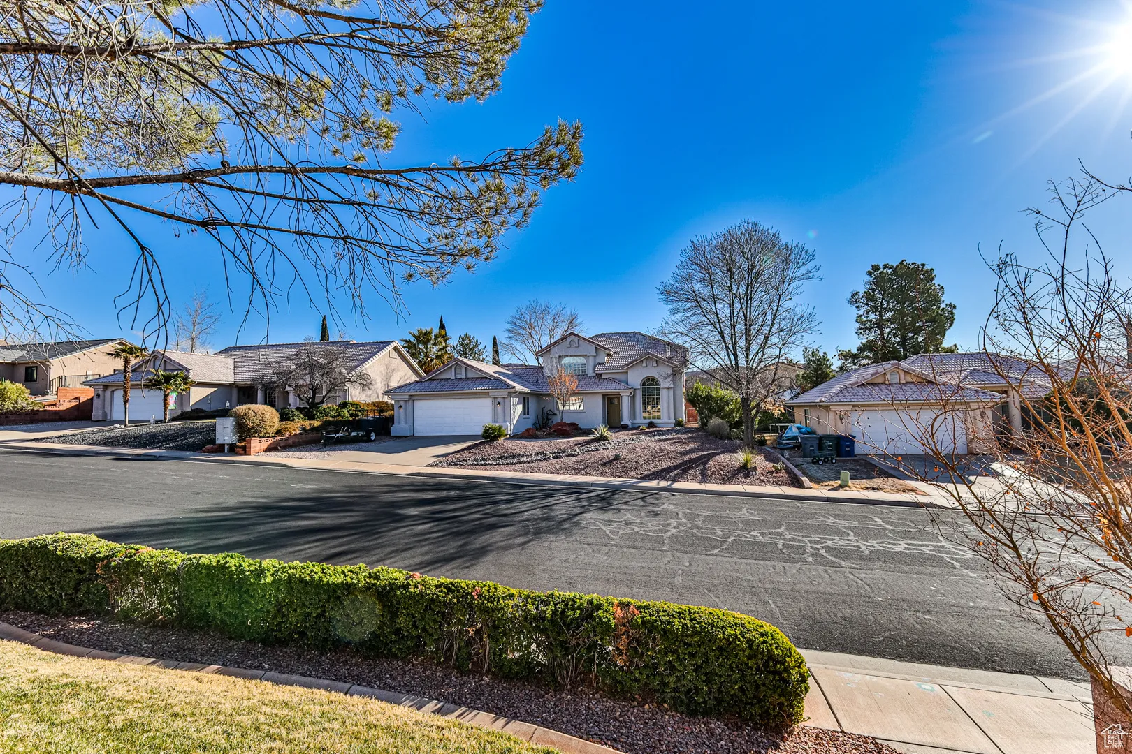 View of front of house featuring a residential view, concrete driveway, and a garage