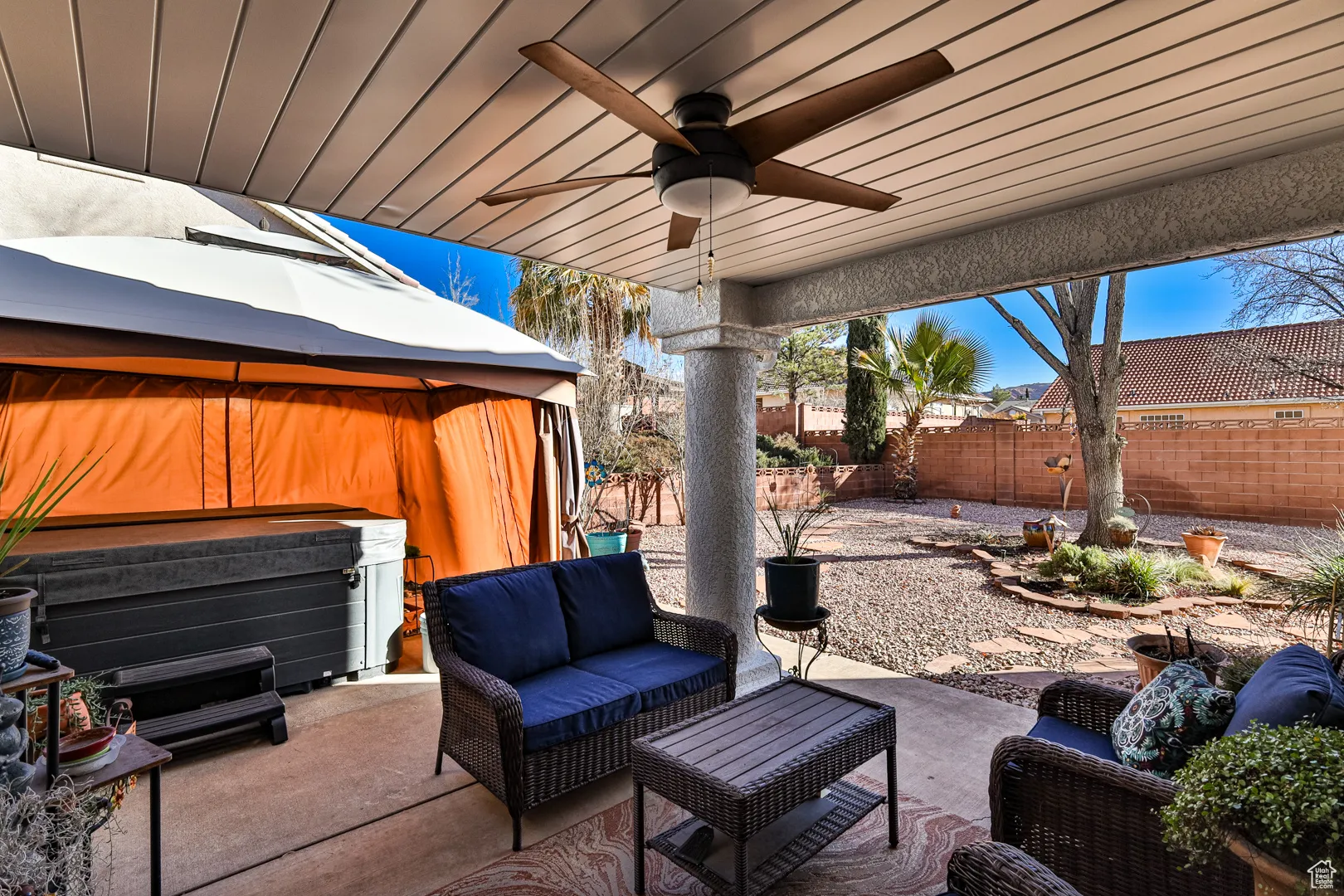 View of patio / terrace featuring an outdoor living space, ceiling fan, a hot tub, and a fenced backyard