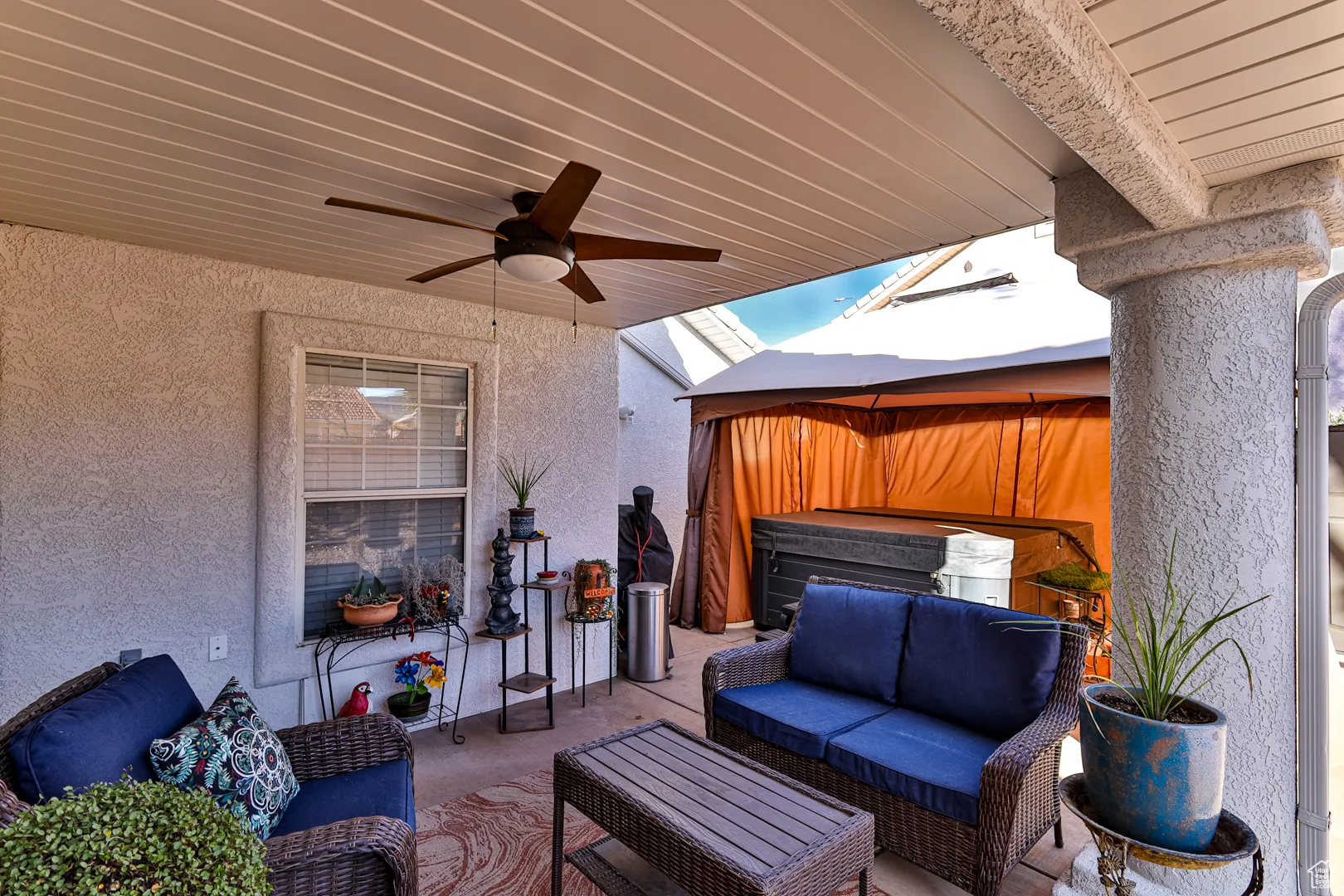 View of patio / terrace featuring a jacuzzi, an outdoor hangout area, a gazebo, and ceiling fan