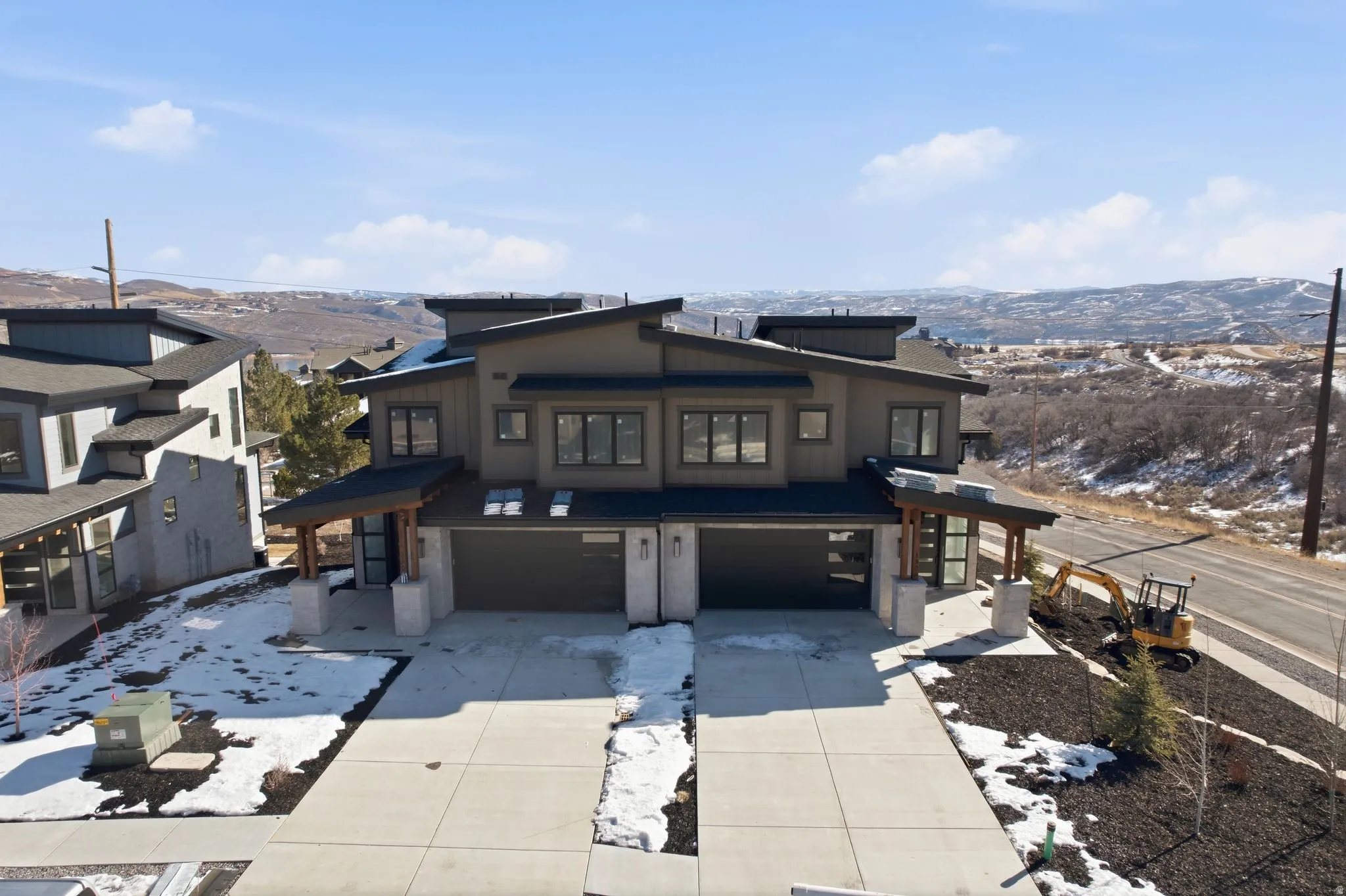 Contemporary home featuring a mountain view, a garage, and concrete driveway