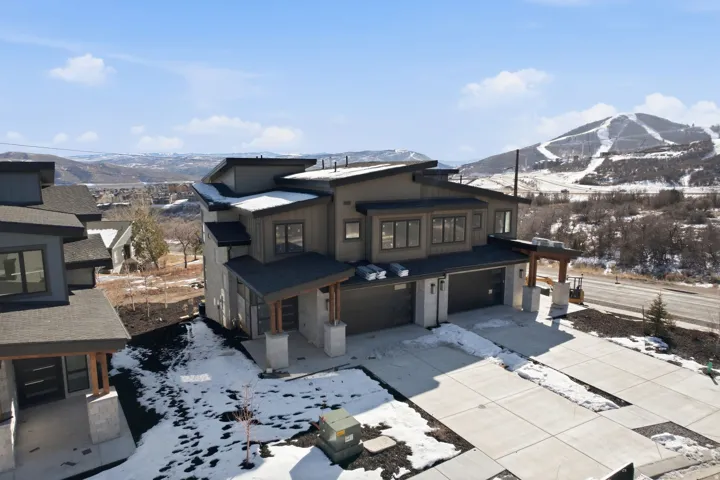 View of front facade with a mountain view, an attached garage, and concrete driveway