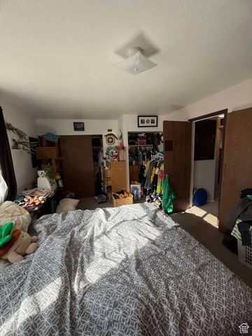Bedroom featuring a closet and a textured ceiling