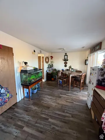 Dining area featuring dark wood-type flooring