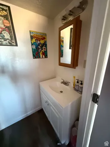 Bathroom featuring vanity and baseboards