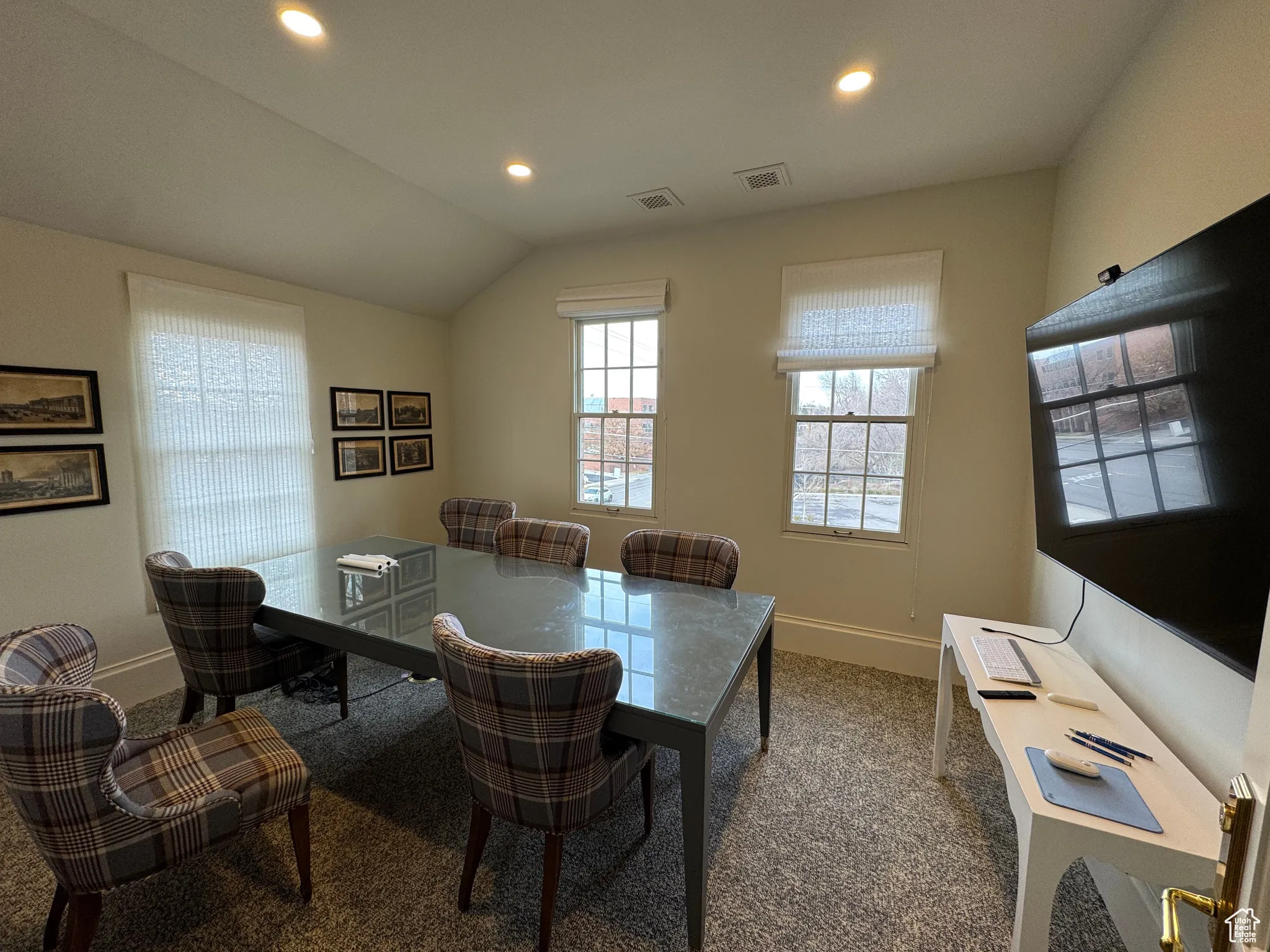 Dining space featuring vaulted ceiling, recessed lighting, baseboards, and carpet floors