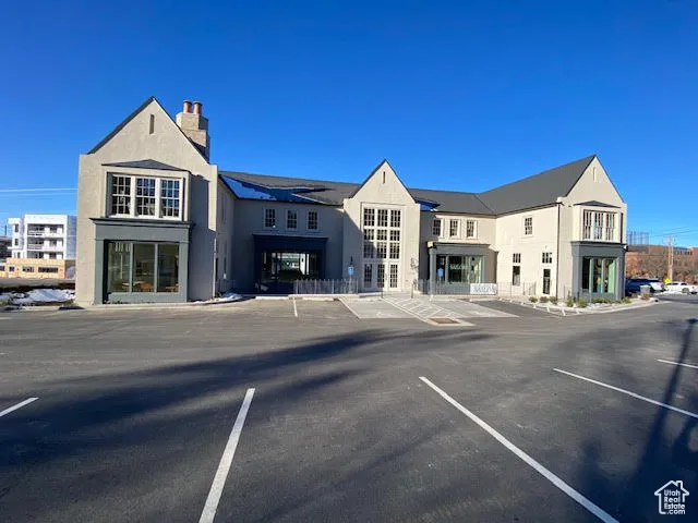 View of building exterior featuring uncovered parking