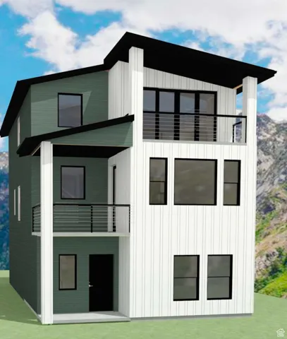 Front view of property with a balcony, board and batten siding, and a lawn