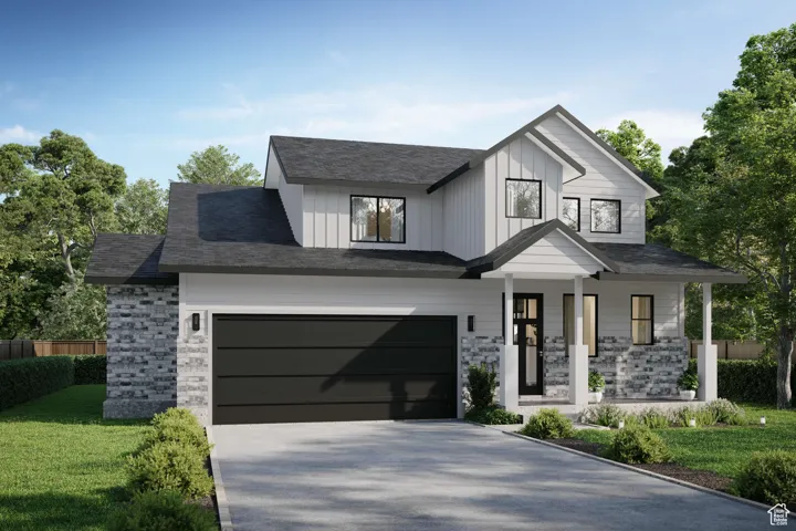 Modern inspired farmhouse featuring a front yard, fence, concrete driveway, stone siding, and board and batten siding