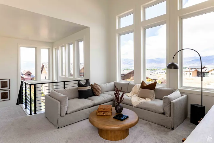 Living area with carpet flooring and a mountain view