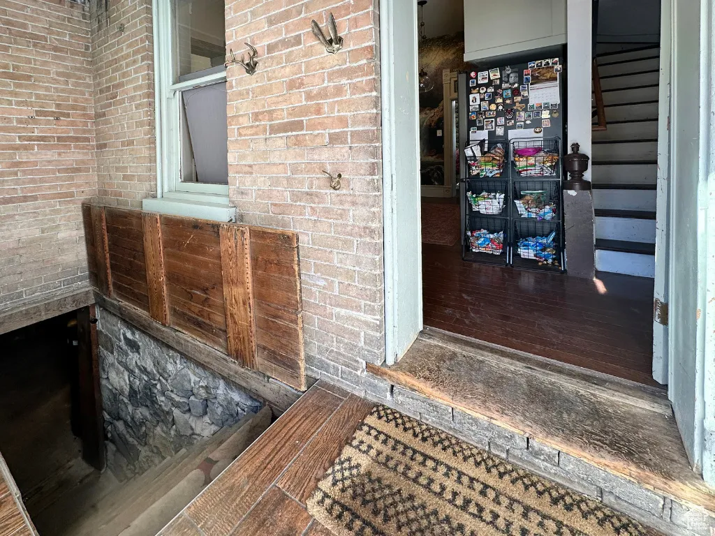 Entrance to property featuring brick siding
