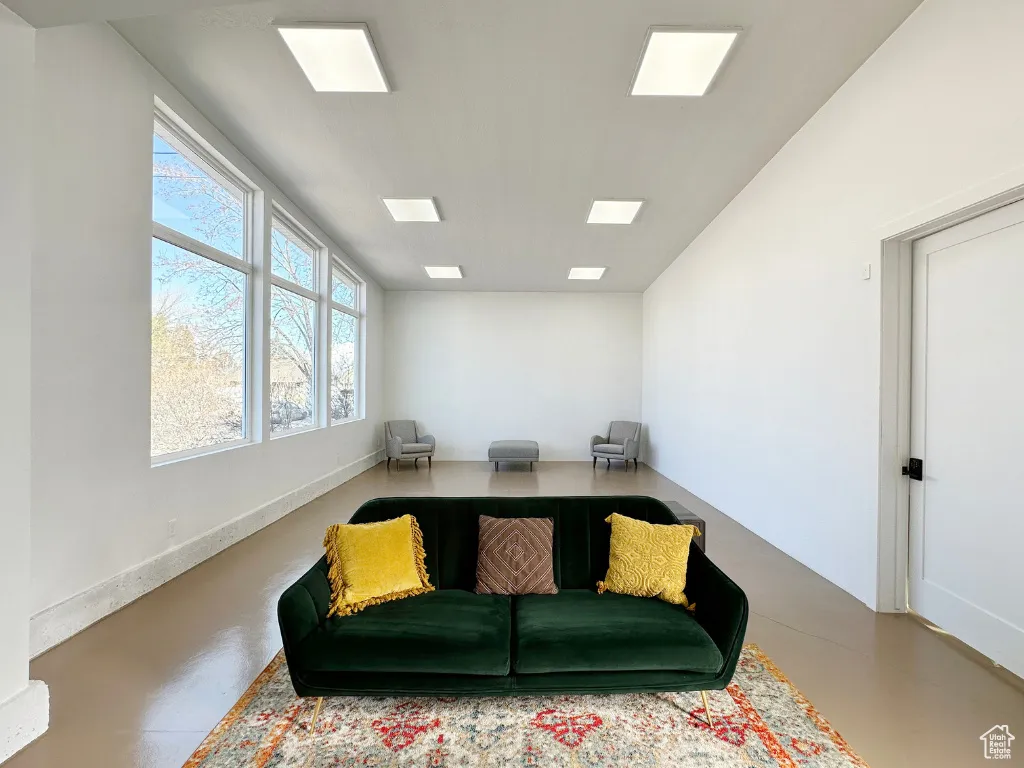 Sitting room featuring finished concrete flooring