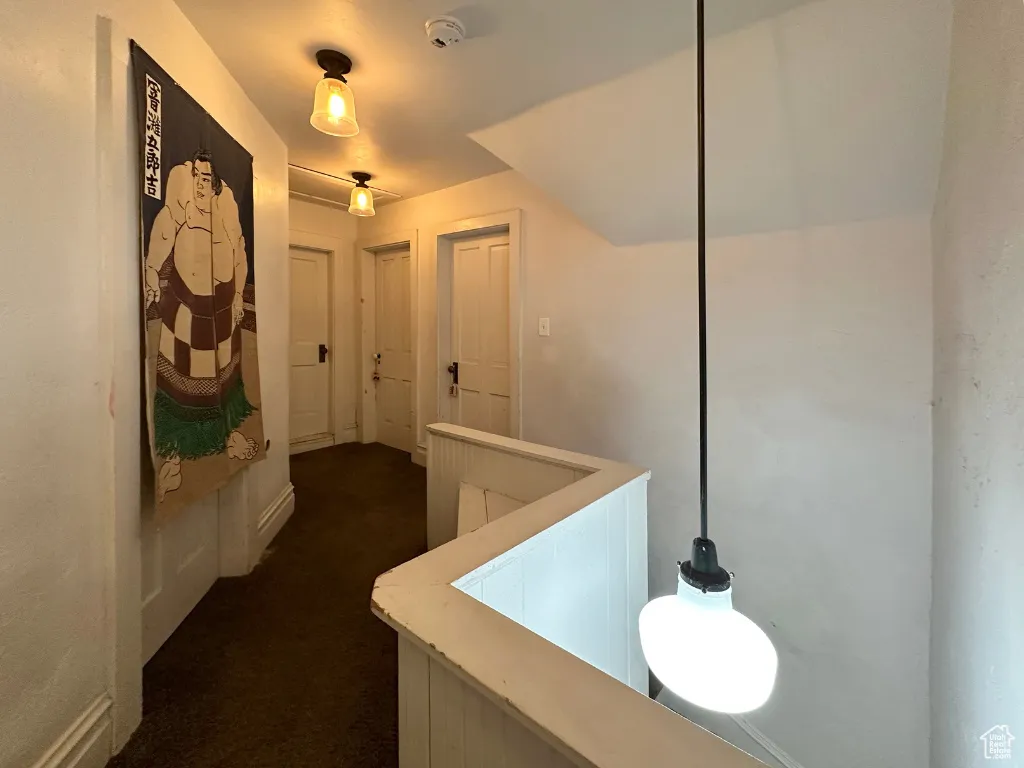 Hallway with dark carpet