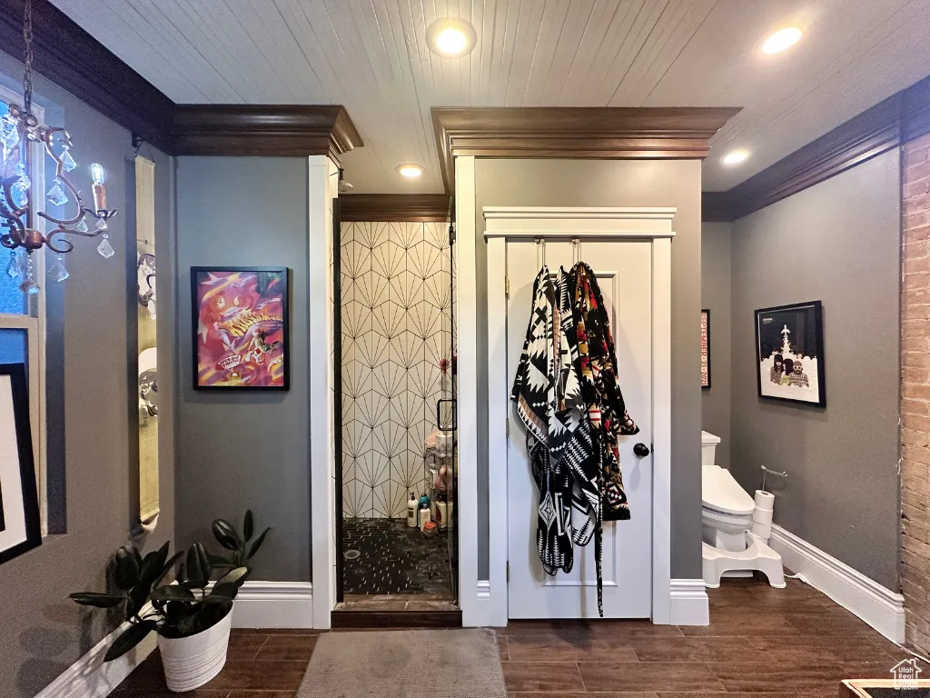 Interior space with wood finish floors, a stall shower, recessed lighting, an inviting chandelier, and wooden ceiling