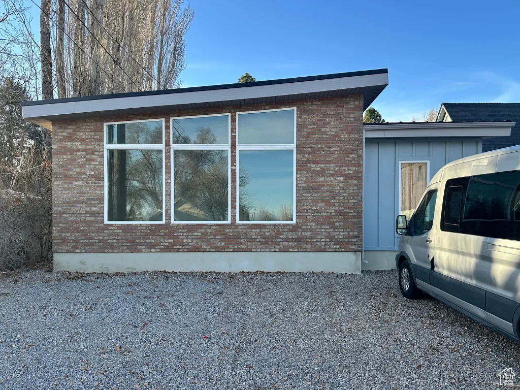 View of home's exterior with brick siding and board and batten siding
