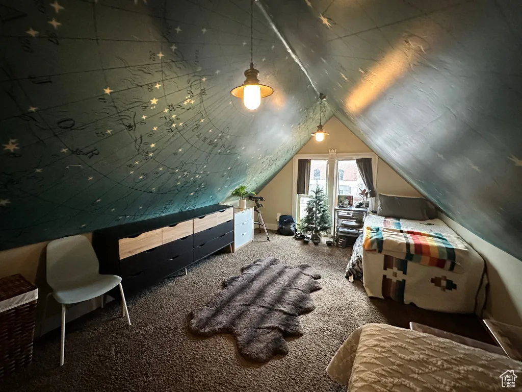 Carpeted bedroom with lofted ceiling