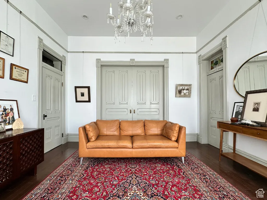 Living room with a notable chandelier and wood finished floors