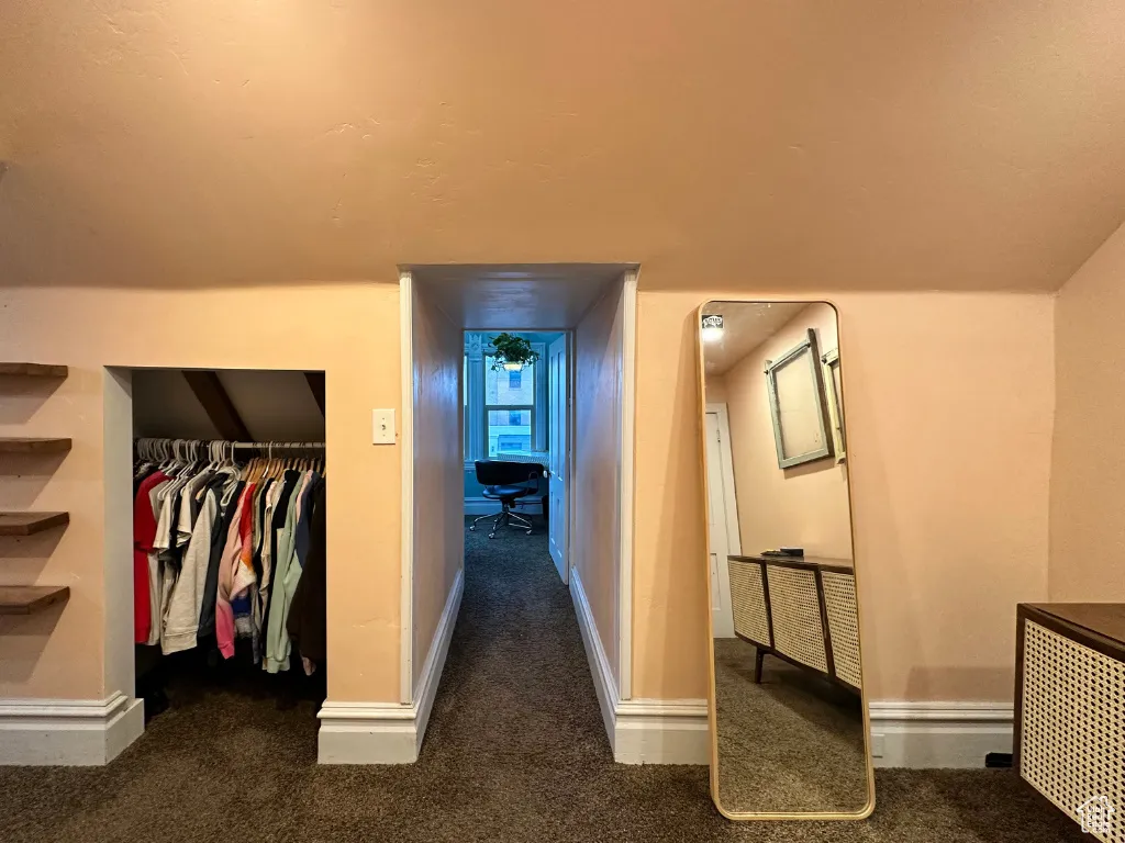 Hall featuring baseboards and carpet floors