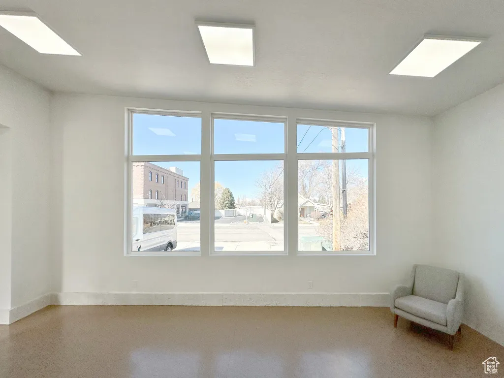 Interior space with speckled floor and baseboards