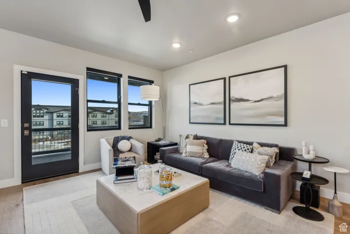 Living area with recessed lighting, baseboards, light wood-style floors, and a ceiling fan