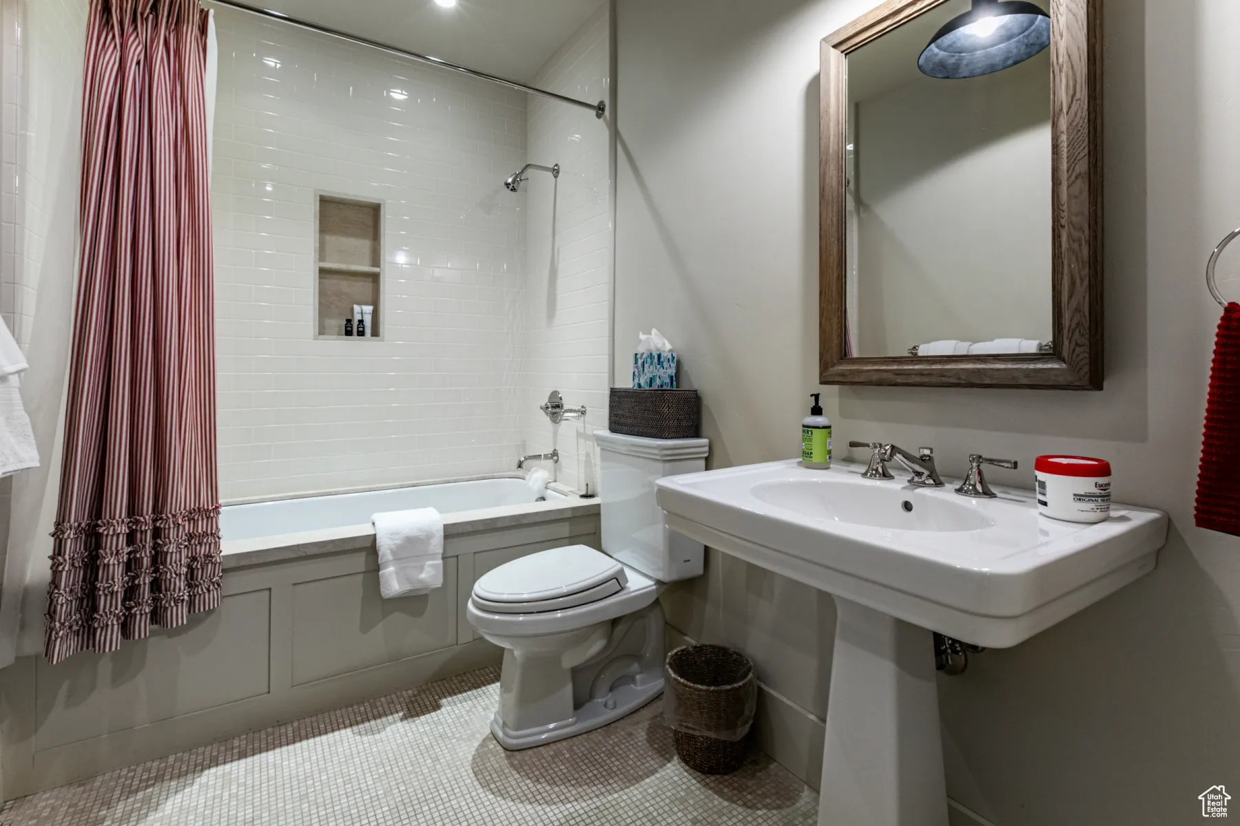 Full bathroom featuring tile patterned floors, toilet, and shower / tub combo