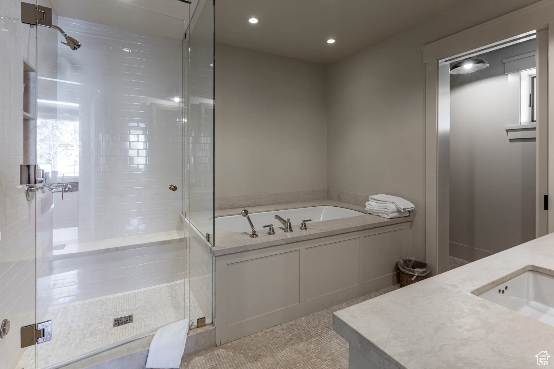 Full bathroom featuring tile patterned flooring, recessed lighting, a stall shower, a bath, and a sink