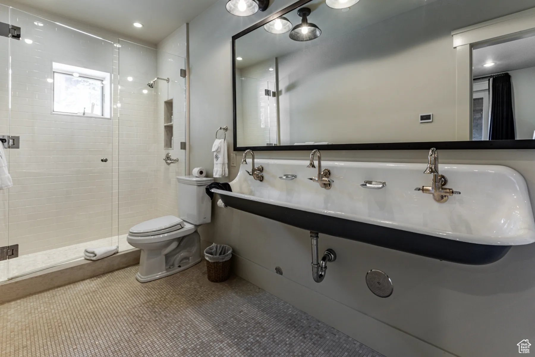 Full bathroom featuring tile patterned floors, a stall shower, and toilet