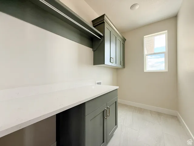 Laundry room with baseboards and hookup for a washing machine