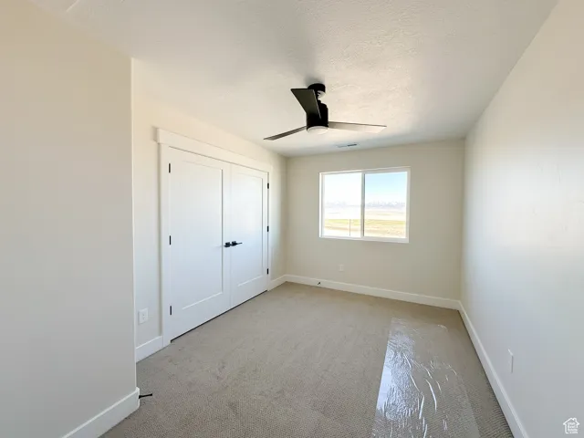 Unfurnished bedroom featuring baseboards, visible vents, and a textured ceiling