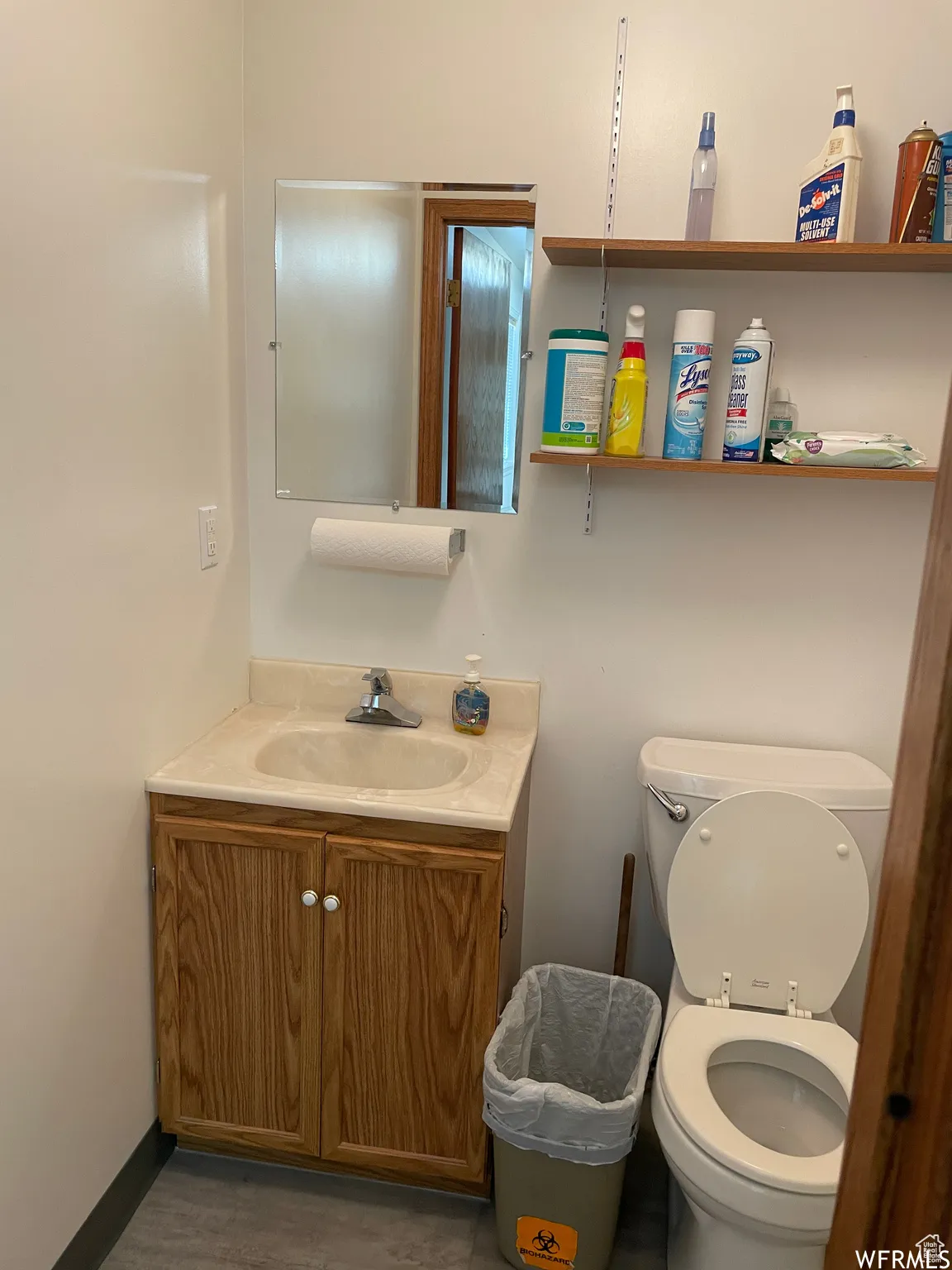 Bathroom with toilet, wood finished floors, and vanity