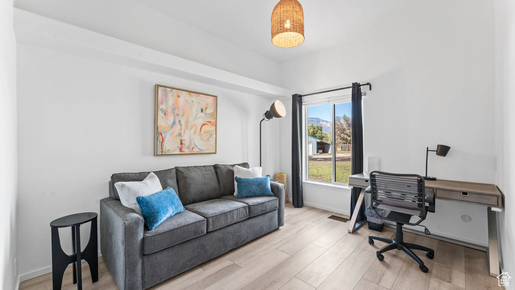 Office with baseboards and light wood-style floors