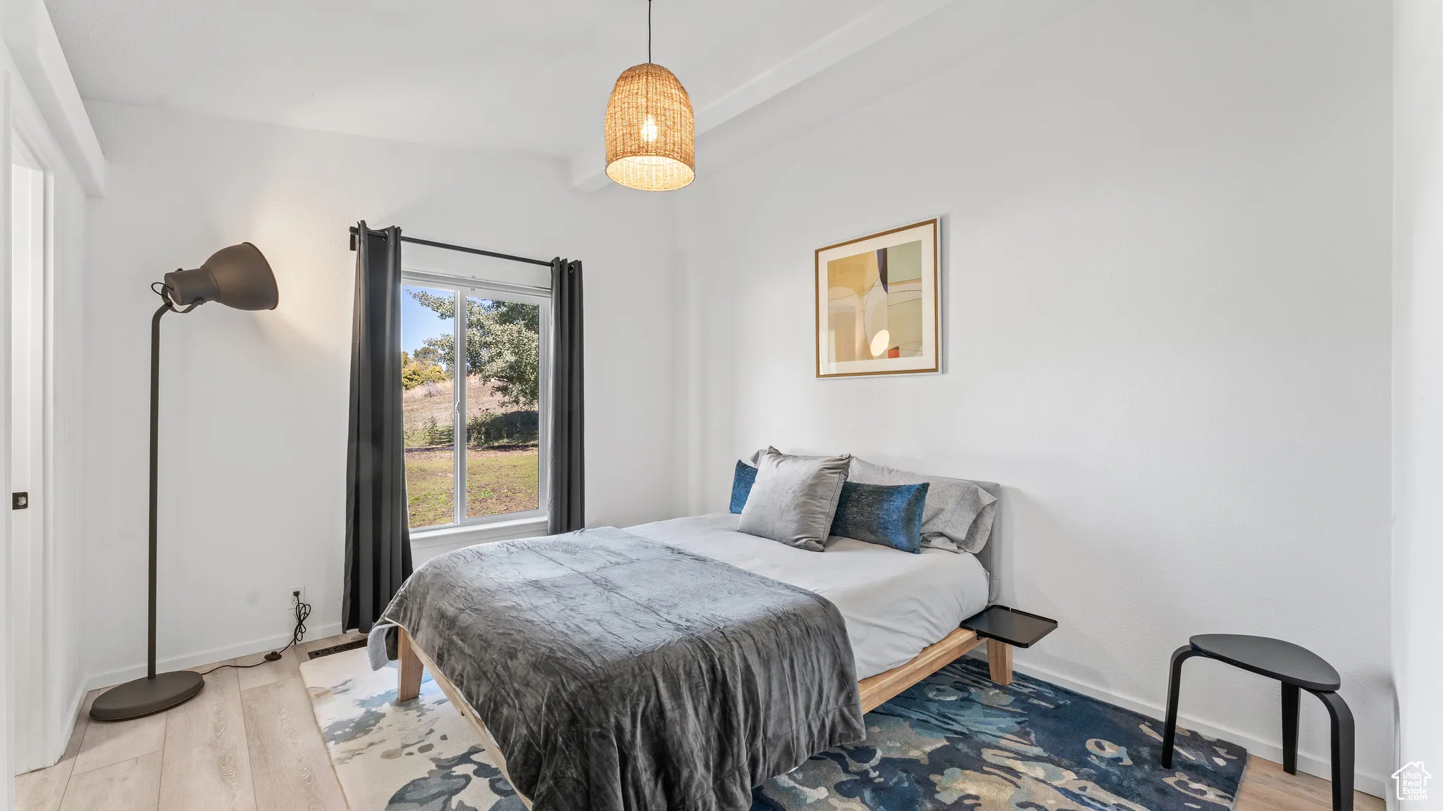 Bedroom with baseboards and light wood-type flooring