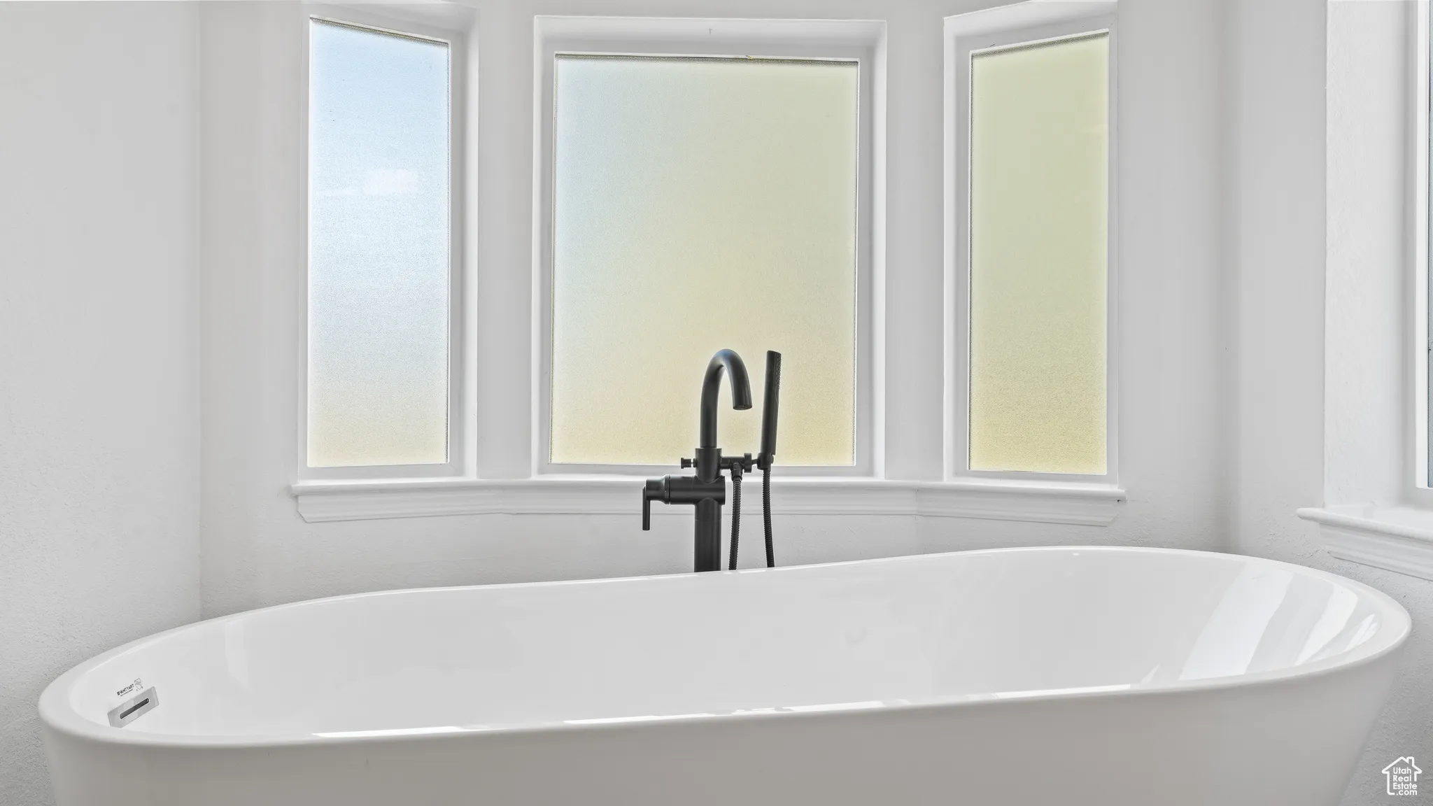 Full bathroom featuring a sink and a soaking tub