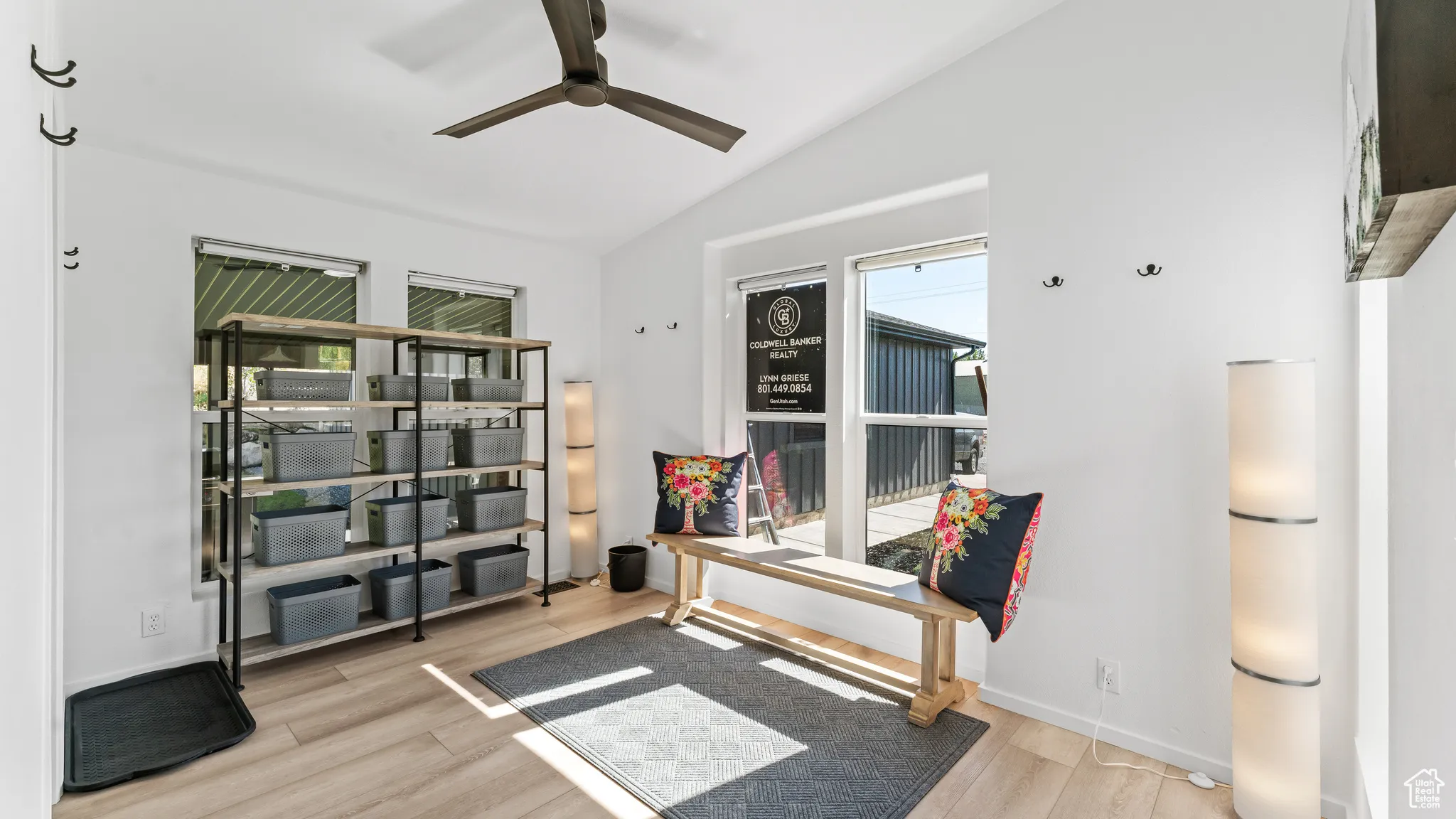 Sitting room featuring baseboards, wood finished floors, ceiling fan, and vaulted ceiling